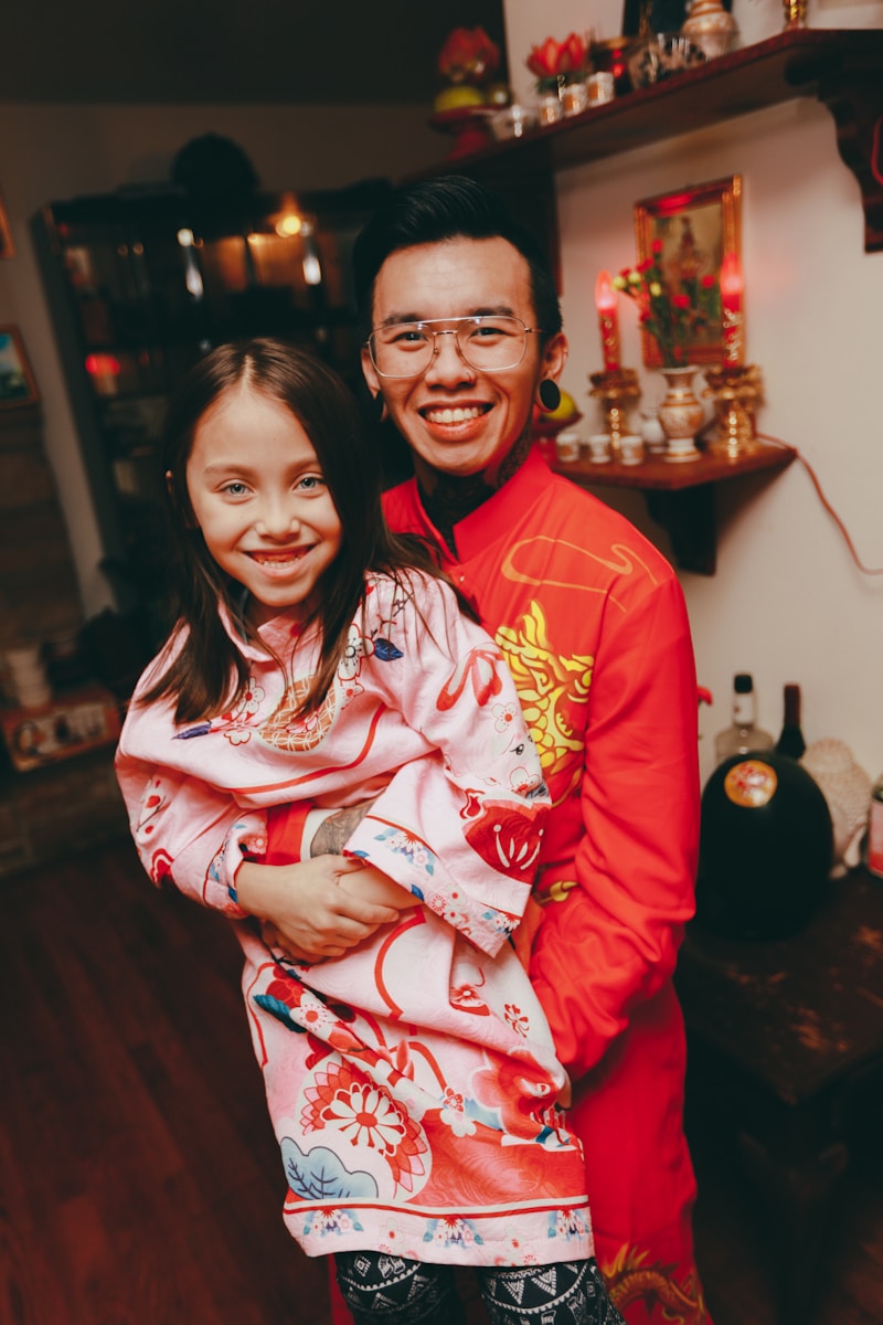 a man holding a girl in a room