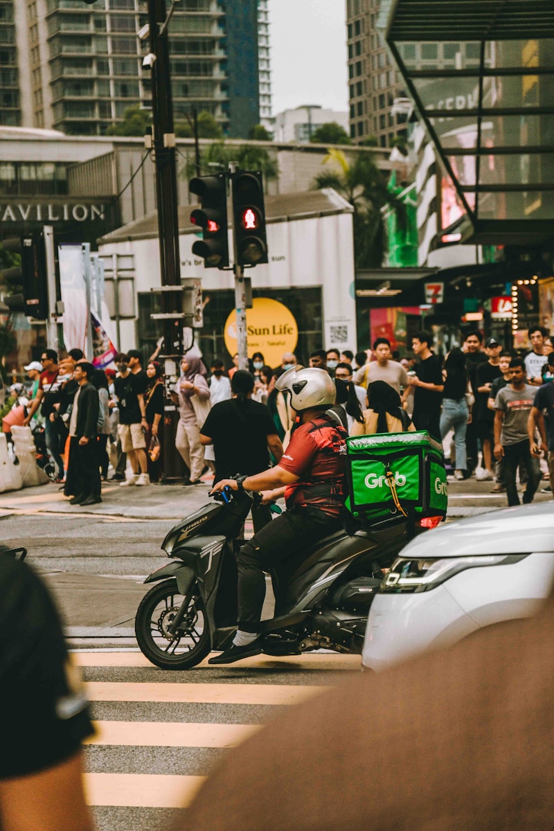 A man riding a motorcycle down a busy street