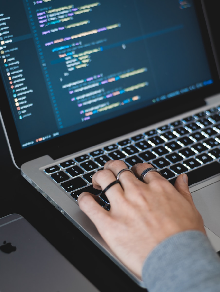 Photo by AltumCode person typing on turned on MacBook