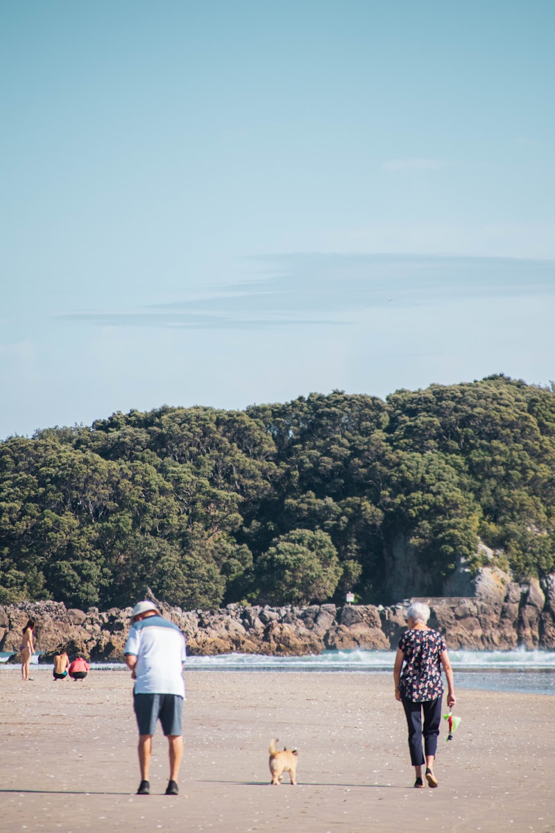 a man and a woman flying a kite on the beach