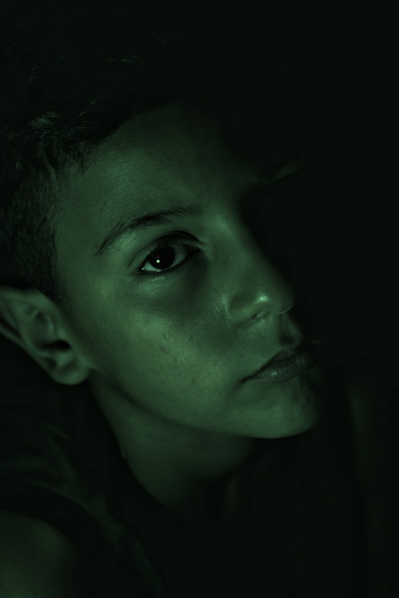 a young boy is staring into the distance