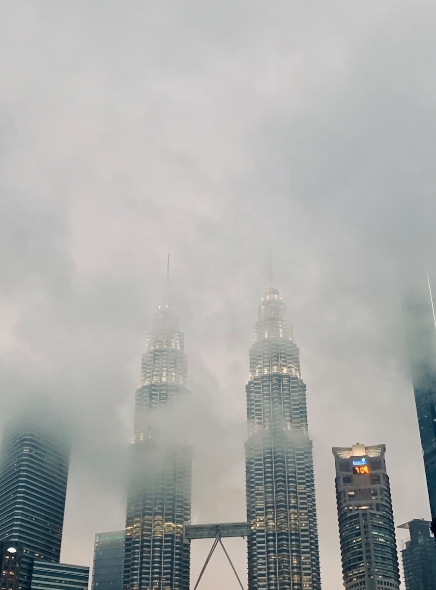 high rise building under white clouds