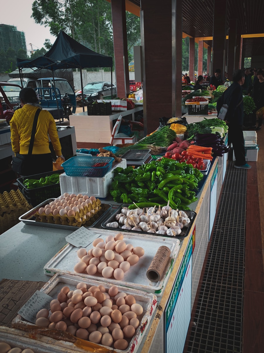 woman in yellow jacket standing in front of fruit stand
