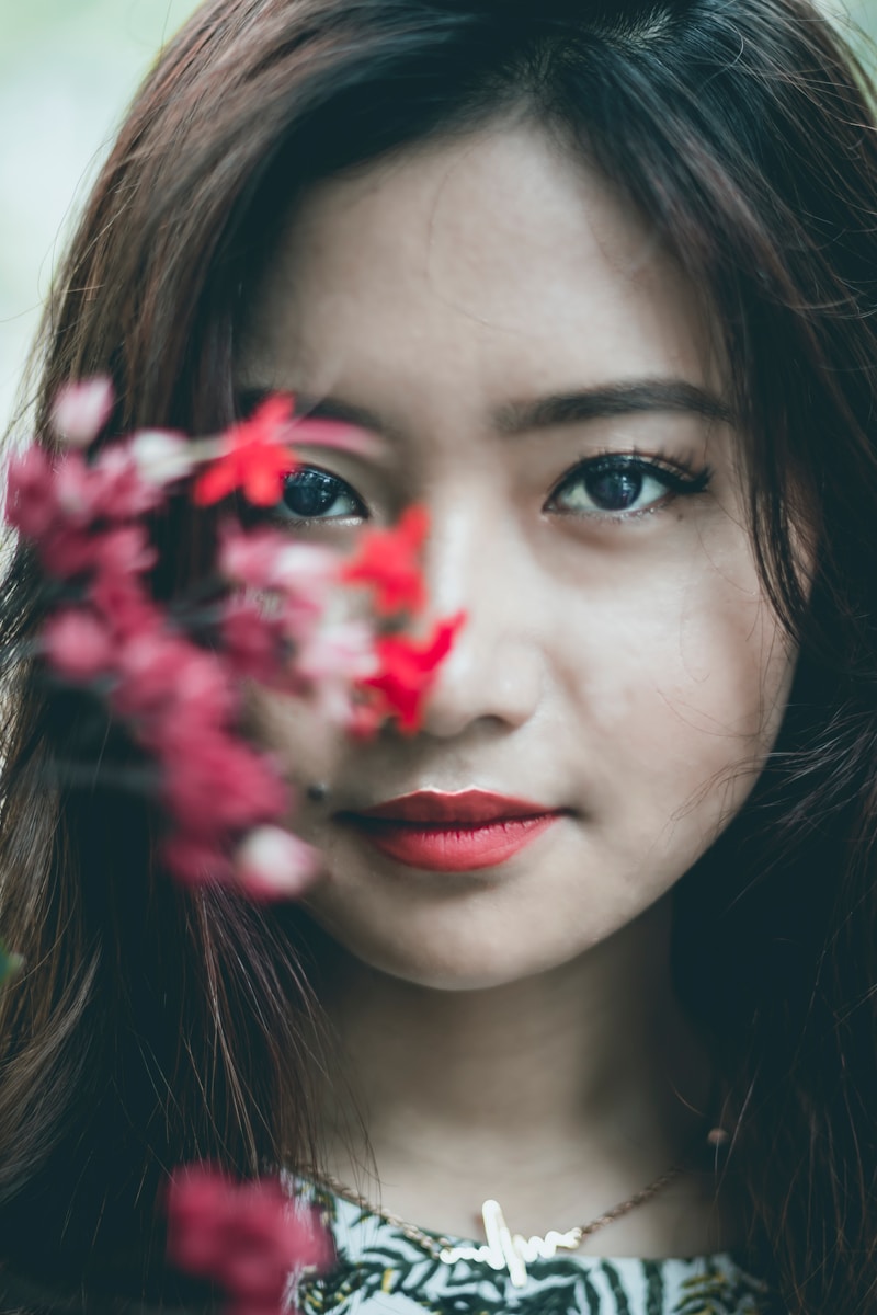 woman near pink petaled flwoer