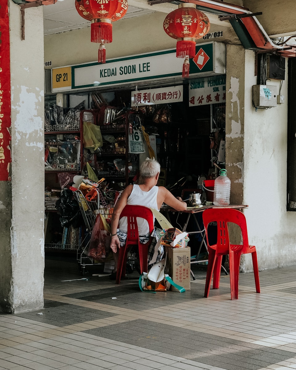 man sitting on chair beside table