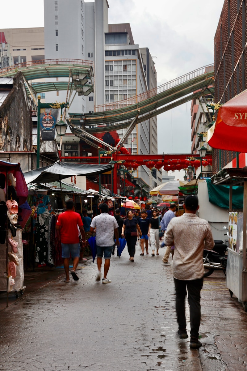 a group of people walking down a wet street