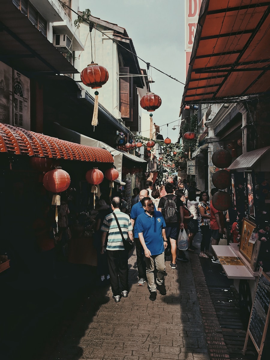 man in blue polo shirt and gray pants walking on pavement