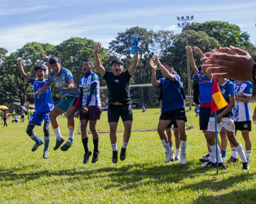 a group of young people playing a game of soccer