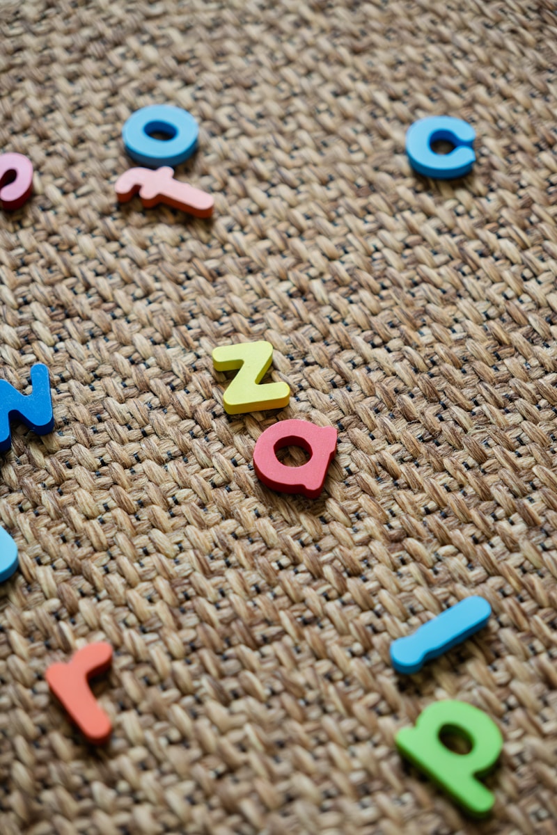 Colorful letters scattered on a textured surface.