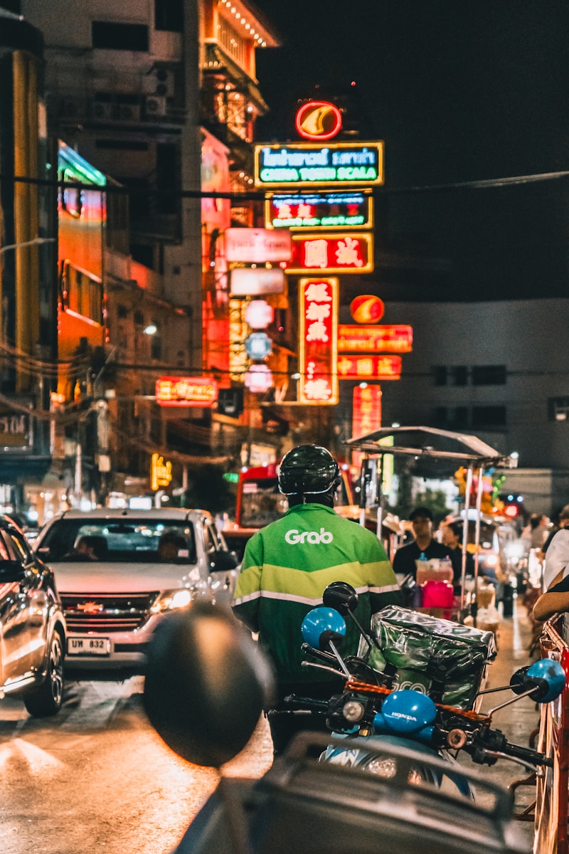 Delivery driver in neon-lit city street at night