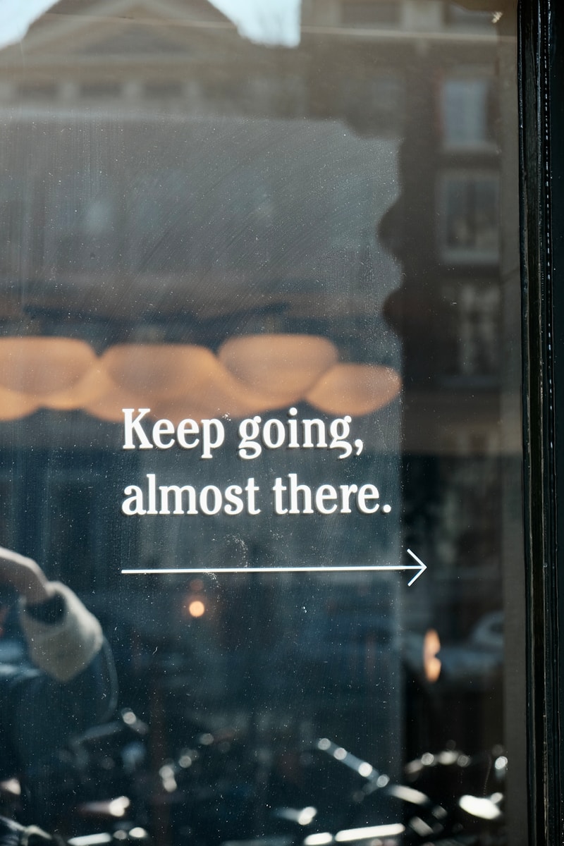 a window with a sign that says keep going, almost there
