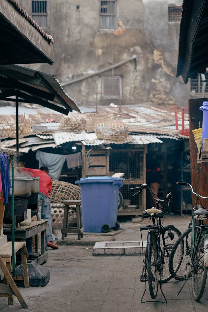 a bicycle parked next to a building on a street