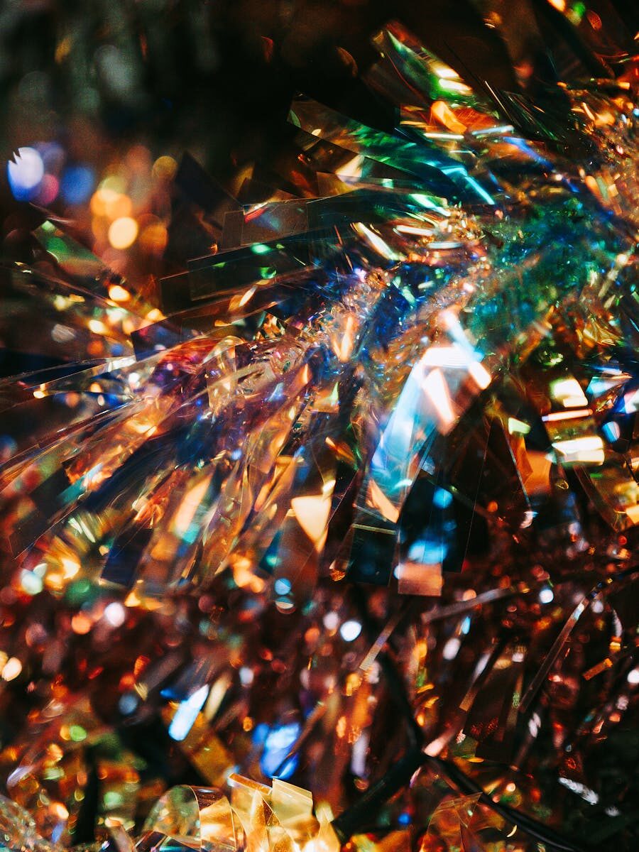Colorful tinsel garland with a glittering bokeh effect, perfect for festive decorations.