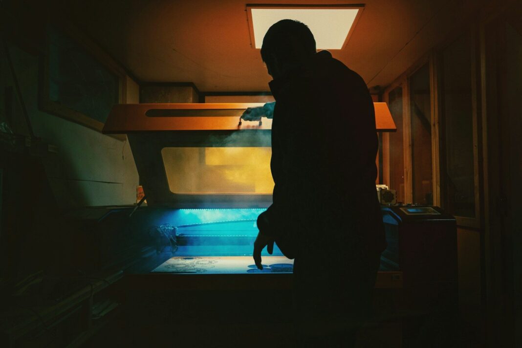 a man standing in a room next to a window