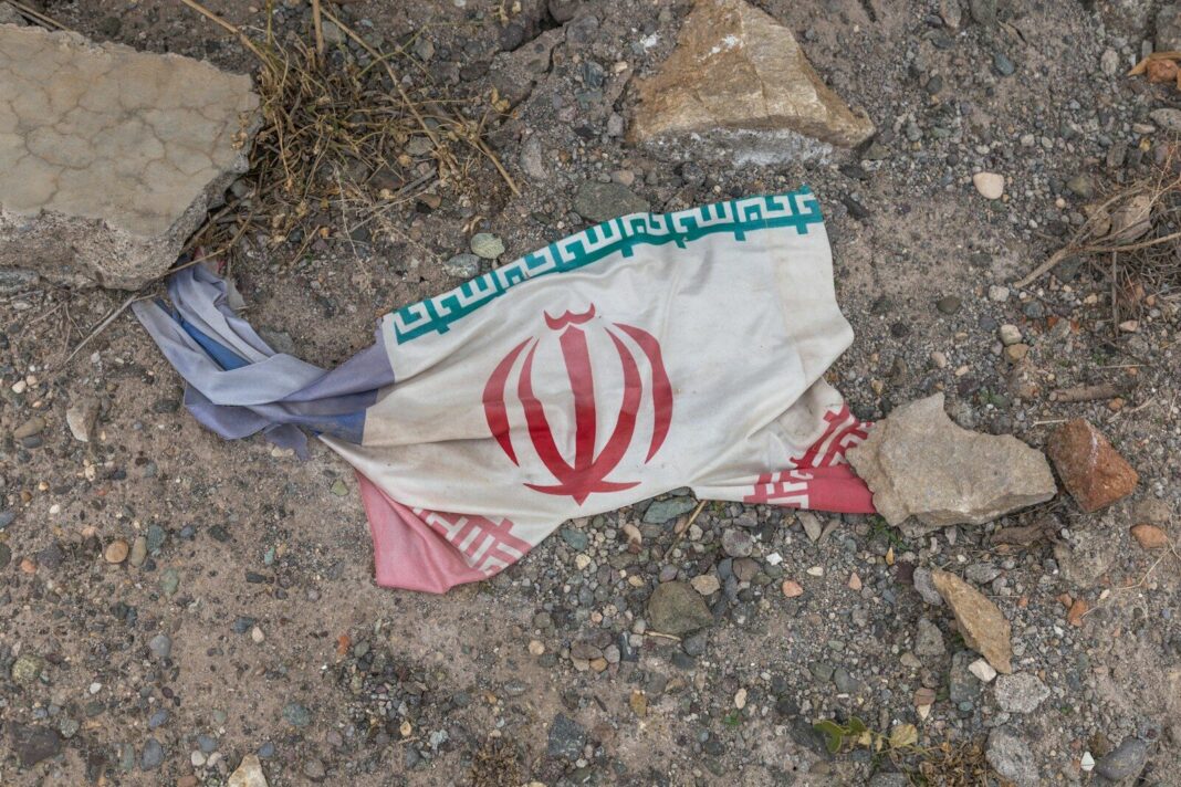 a flag laying on the ground next to rocks