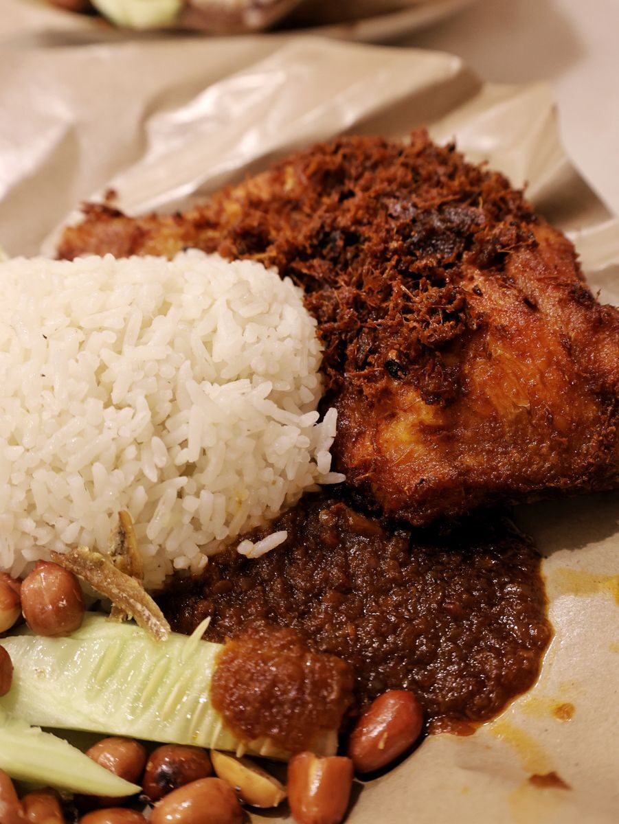 Close-up of traditional Nasi Lemak with fried chicken in Kuala Lumpur, Malaysia.