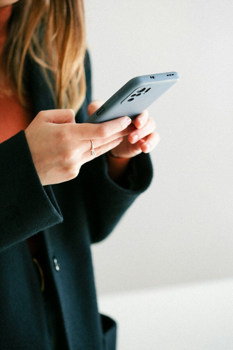 a woman holding a cell phone in her hands