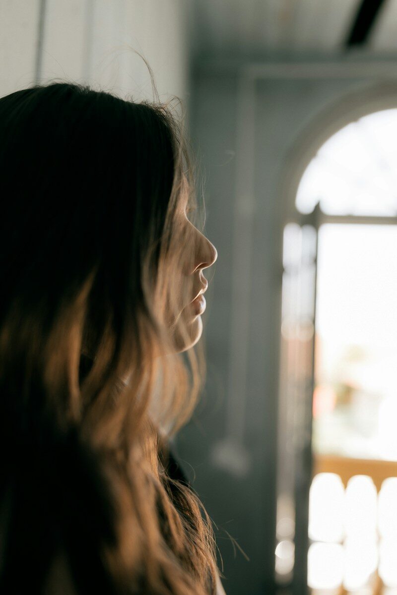 Profile of a young woman with long, wavy hair